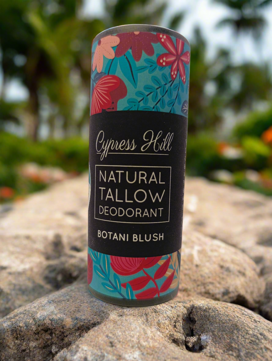 Cypress Hill natural tallow deodorant canister with floral design on a rock